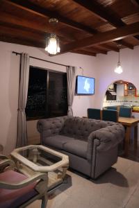 a living room with a couch and a tv at Wonderful house with views in Medellin-fiber optics in Medellín