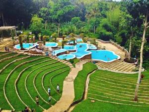 a resort with several pools in a park at Casa Mercado I in Lipa
