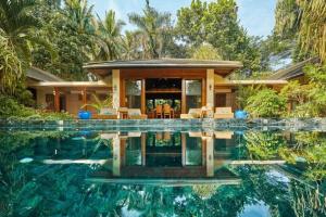 a house with a swimming pool in front of a house at Casa Mercado I in Lipa