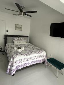 a bedroom with a bed and a ceiling fan at Casa West Miami in Miami