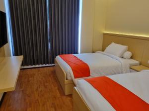 Ein Bett oder Betten in einem Zimmer der Unterkunft core inn juwita hotel