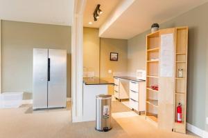 a kitchen with a refrigerator in the middle of a room at Kelowna Spacious 3 Bedroom House in Kelowna