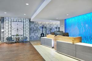 a lobby with a reception desk with a blue wall at Fairfield Inn and Suites by Marriott Nashville Downtown/The Gulch in Nashville