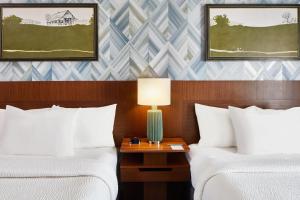 a hotel room with two beds and a table with a lamp at Fairfield Inn and Suites by Marriott Nashville Downtown/The Gulch in Nashville