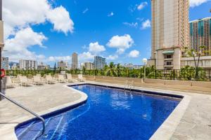 a swimming pool on the roof of a building at CASTLE at Palms at Waikīkī in Honolulu
