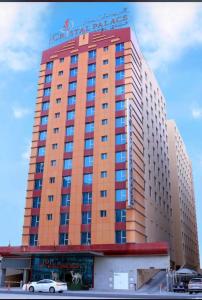 a large building with a sign on top of it at Crystal Palace Hotel in Manama