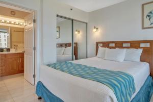 ホノルルにあるGorgeous High Rise Waikiki Condo with Ocean and Diamond Head Viewsの大きなベッドとバスルームのある寝室