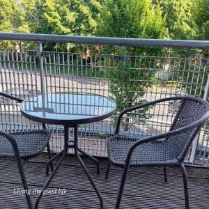 a table and two chairs sitting on a patio at Balcony-view with Free and secured Parking in Manchester