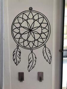 a dream catcher wall decal on a door at Maga hospedagem in Penha