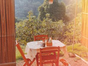a table and chairs on a porch with a view of a garden at Phu Morinn Cafe &Camping Monjam in Mon Jam +133 photos