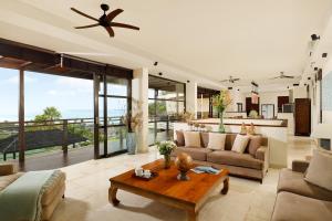 a living room with a couch and a table at Villa Jamalu by Nakula in Jimbaran