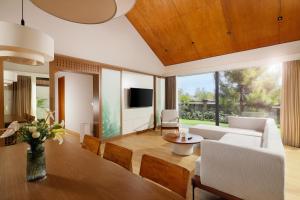 a living room with a couch and a tv at Dusun Bedugul Asri in Bedugul