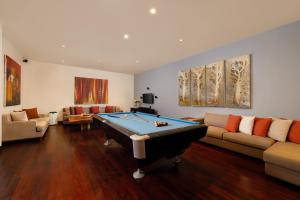 a living room with a pool table in it at Villa Jamalu by Nakula in Jimbaran