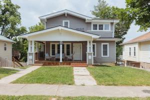 a white house with a porch and a yard at Sage Haven #6 in Johnson City