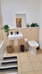 a bathroom with a sink and a toilet at Balcony-view with Free and secured Parking in Manchester