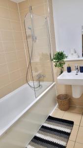 a bathroom with a shower and a sink at Balcony-view with Free and secured Parking in Manchester