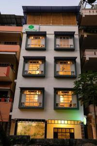 a tall white building with many windows at Namastay Leisure Homes in Kovalam