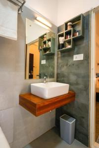 a bathroom with a sink and a mirror at Namastay Leisure Homes in Kovalam