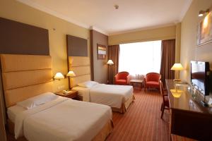 Postel nebo postele na pokoji v ubytování Dynasty Hotel Miri + 37 fotografií