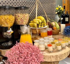 a table filled with different types of food and drinks at White Lotus Saigon Hotel in Ho Chi Minh City