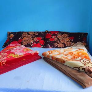 two pillows sitting on a bed next to each other at White Lotus in Tosh הלוטוס הלבן -בטוש in Tosh