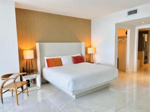 a bedroom with a large white bed and a chair at Dramatic Ocean View at Hyde Resort And Residences in Hollywood