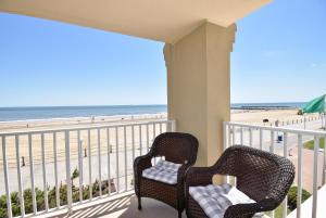 two chairs on a balcony with a view of the beach at Dolphin Run in Virginia Beach
