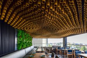 a dining room with a long table and chairs at Regenta Place Raysons Kolhapur in Kolhapur