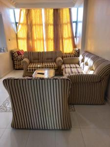 a living room with two couches and a table at Apartment El Jadida in El Jadida