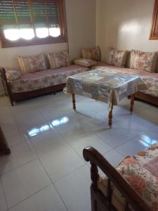 a living room with a couch and a table at Apartment El Jadida in El Jadida