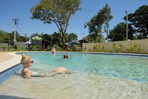a woman sitting in a swimming pool at Discovery Parks - Darwin in Darwin +10 photos