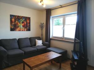 a living room with a couch and a table at Barrierefreies Appartement auf der Alb in Trochtelfingen