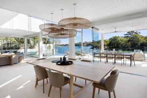 an open dining room with a wooden table and chairs at 12 Noosa Parade, Noosa Heads in Noosa Heads