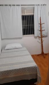 a bedroom with a bed and a window at Espaço Alternativo in Recife