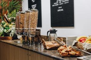 a buffet with bread and other food on a counter at Banjo Paterson Inn in Jindabyne