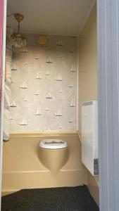 a bathroom with a toilet with sails on the wall at Aspö Glamping in Drottningskär