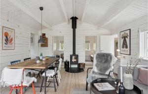 een woonkamer met een tafel en een open haard bij Stunning Home In lbk With Kitchen in Ålbæk
