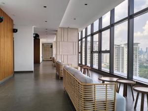 a waiting room with chairs and tables and windows at The Pano Jalan Ipoh Sentul by Kenangan Homes in Kuala Lumpur +41 photos