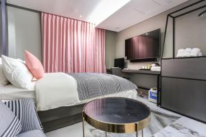 a hotel room with a bed and a table at The Post Hotel in Seoul