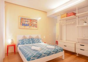 a small bedroom with a bed and a dresser at Ca' Venissa in Venice