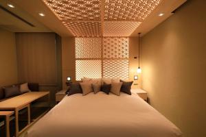 Postel nebo postele na pokoji v ubytování Hotel Gion Ichirin