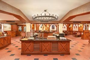 a large kitchen with a chandelier in a room at The Cama - A Sabarmati Riverfront Hotel in Ahmedabad