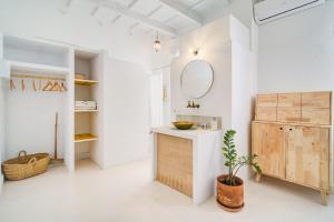 a bathroom with a sink and a mirror at La Cayena Rooms in Ciutadella