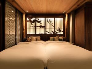 Postel nebo postele na pokoji v ubytování Hotel Gion Ichirin