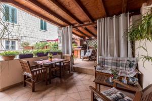 an outdoor patio with a table and chairs at Apartments and Rooms Villa Lina in Split