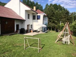 a yard with two nets and a house at Chata Studnička Šumiac in Šumiac