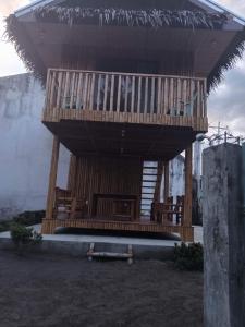 a large wooden building with a deck on top at Brigitte´s Rental House in Dauin