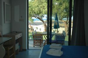a room with a view of a table and chairs at Electra Studios in Gerani