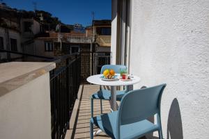 a table and chairs on a balcony with a drink at Pupatella Luxury Suite in Sorrento