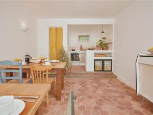 a kitchen and dining room with a table and chairs at La Boule d'Or - Auberge créative in Clamecy